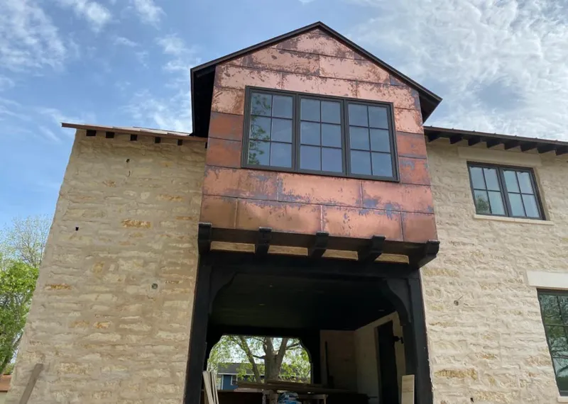 Copper metal panel facade on a stone building for Skylight Installation in Millbrook